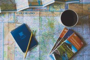 Map of Colorado, p ad and pencil, cup of coffee. Photo by John Matychuk on Unsplash