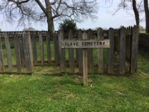 Wooden fence and slave cemetery sign.