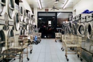 Laundry mat with lines of washers and dryers.