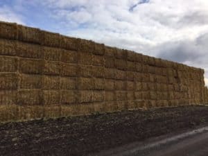Long row of stacked hay.