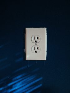 Electrical outlet on blue background.