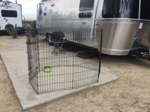 Wire fencing for pets, in front of an Airstream trailer.