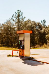 Lone orange and cream colored gas pump.