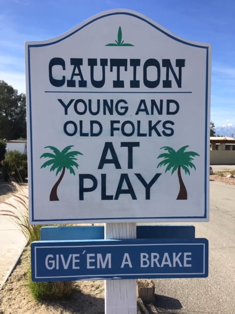 Sign inside an RV park that reads, "Caution Young and old folks at play. Give 'em a brake."