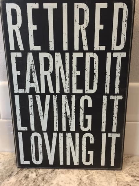Sign that reads, "Retired. Earned it. Living it. Loving it."