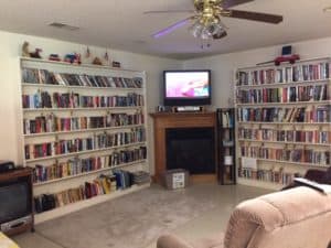 Two walls of books on shelves. A television in the corner.