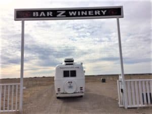 The back of a trailer trailer under the entrance sign overhead that reads Bar Z Winery.