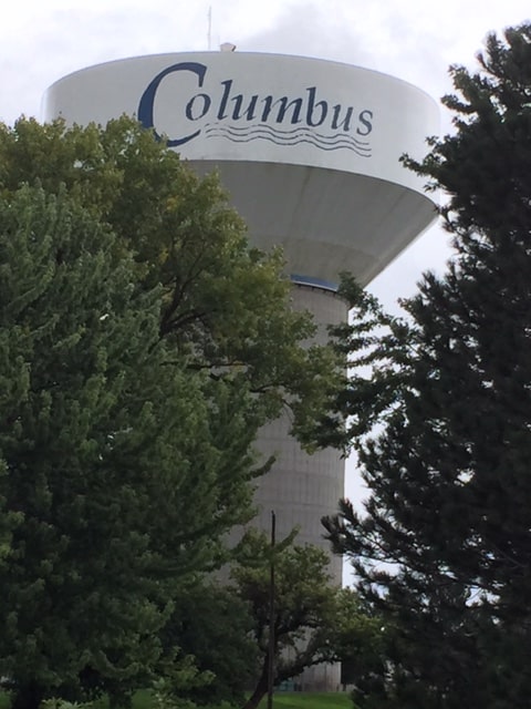 A water tower surrounded by trees. You can read the top where is says Columbus.