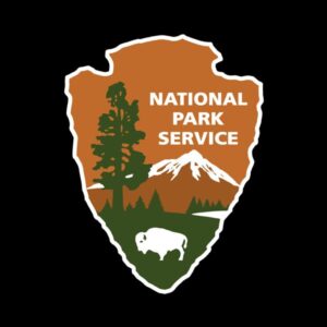 National Park Service logo - shaped like an arrowhead with a tree, mountain and buffalo on it.