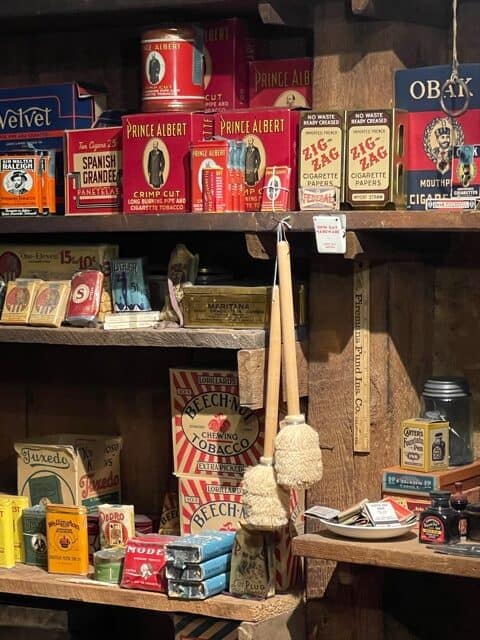 Shelfs with displays of many old tobacco products.