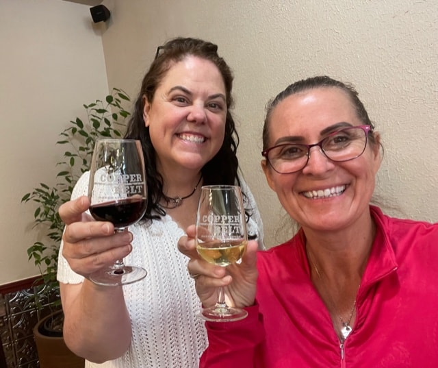 Two women each with a glass of wine. 