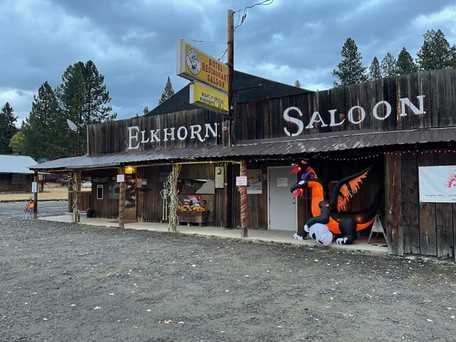 Wooden saloon with Halloween decorations in front. It says, "Elkhorn Saloon."