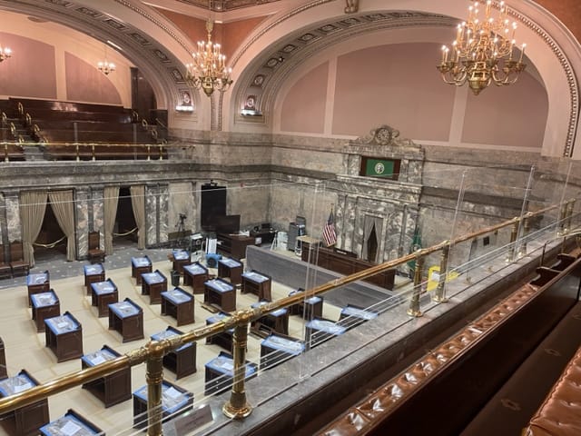 From the balcony above, the Senate floor with rows of desks. Another balcony is on the other side.